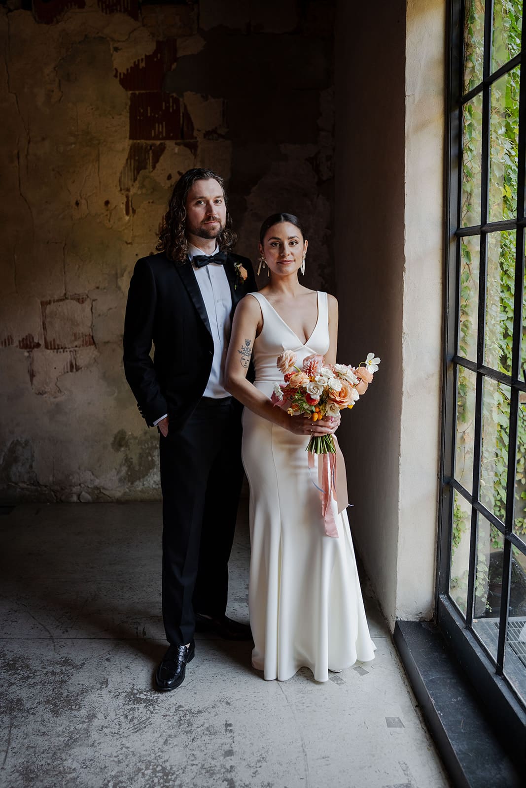 Holly and Ian standing together during their intimate Chicago wedding at the Charcoal Factory, photographed by Dahli Durley.